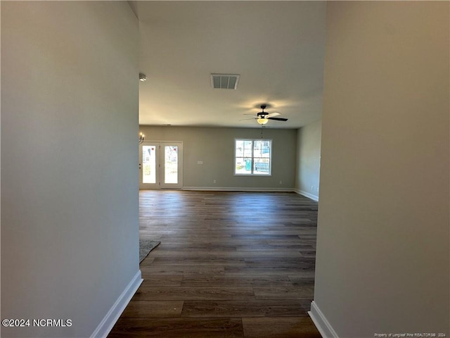 unfurnished room featuring dark wood-type flooring and ceiling fan