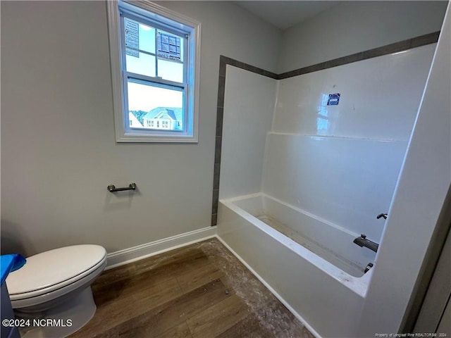 bathroom with toilet, shower / bath combination, and hardwood / wood-style floors