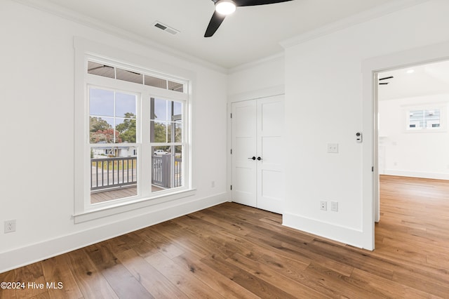 unfurnished room with wood-type flooring, ceiling fan, and ornamental molding