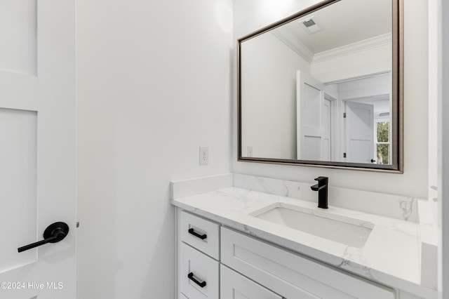 bathroom featuring vanity and ornamental molding