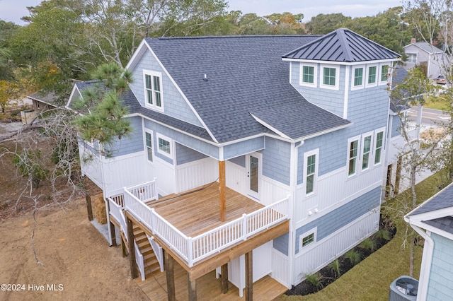 rear view of house featuring a wooden deck