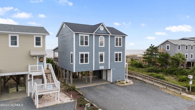 raised beach house featuring a carport