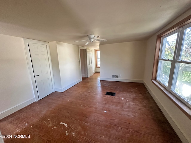 spare room featuring ceiling fan and dark hardwood / wood-style flooring