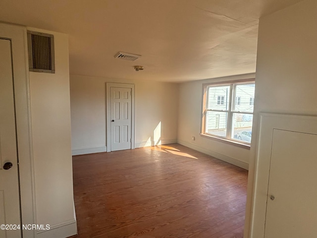 spare room with hardwood / wood-style flooring