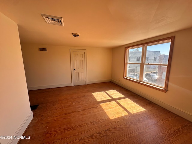 spare room featuring hardwood / wood-style floors