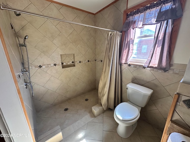 bathroom featuring tile patterned flooring, walk in shower, toilet, crown molding, and tile walls