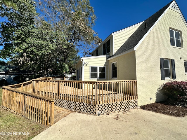 back of property featuring a wooden deck