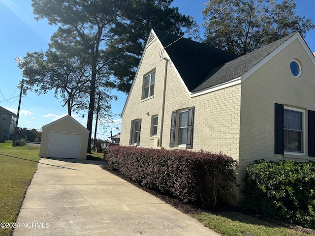 view of side of property with a garage and an outdoor structure