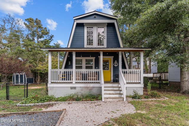 view of front of house with a gate, crawl space, fence, and covered porch