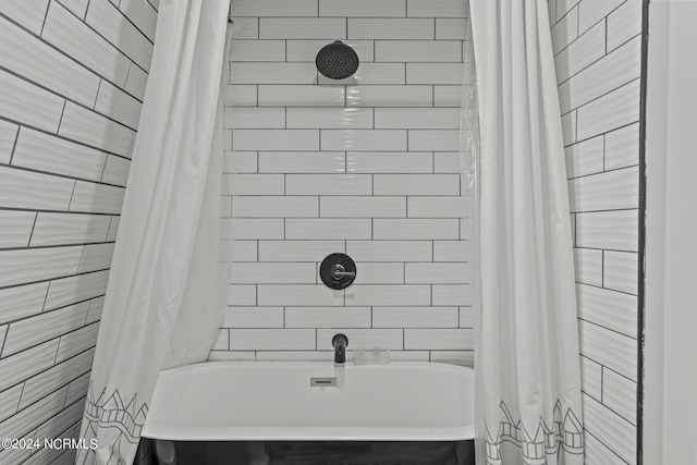 bathroom with shower / bath combination with curtain