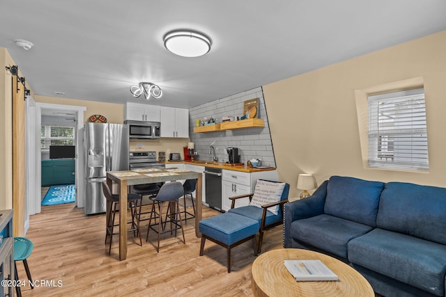 412 Womble St, Oak Island, NC 28465 - living room featuring light wood finished floors and a barn door