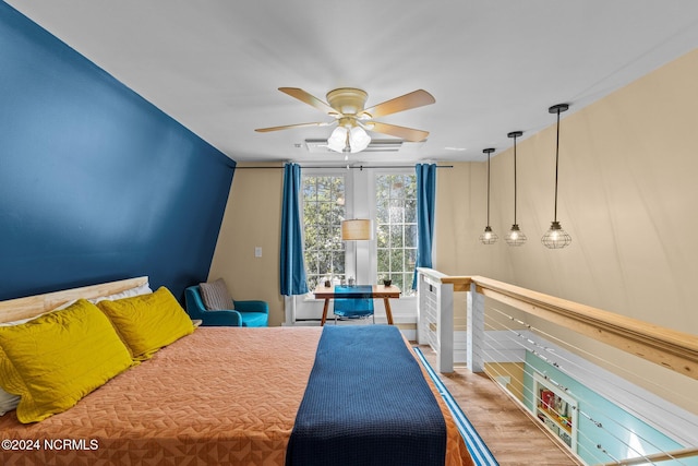 bedroom with wood-type flooring and ceiling fan