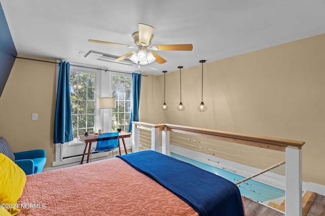 bedroom featuring ceiling fan, baseboards, and wood finished floors