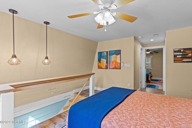 412 Womble St, Oak Island, NC 28465 - bedroom with wood finished floors, ceiling fan, and baseboards
