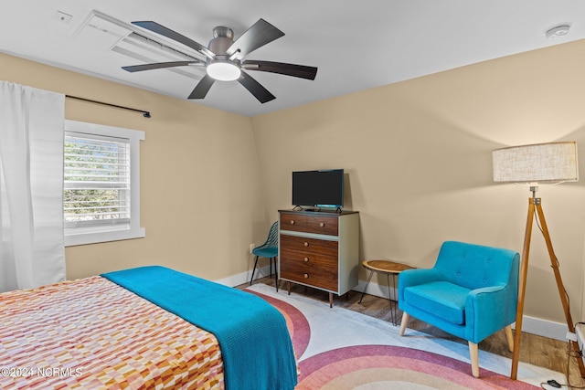 bedroom with baseboards, a ceiling fan, and wood finished floors
