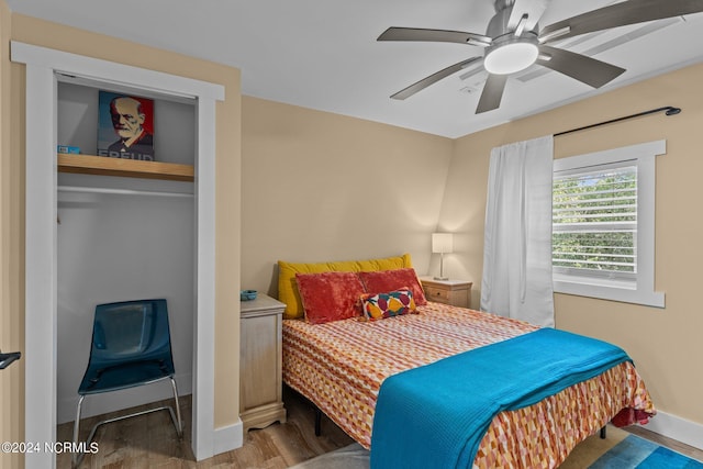 bedroom with ceiling fan, baseboards, and wood finished floors
