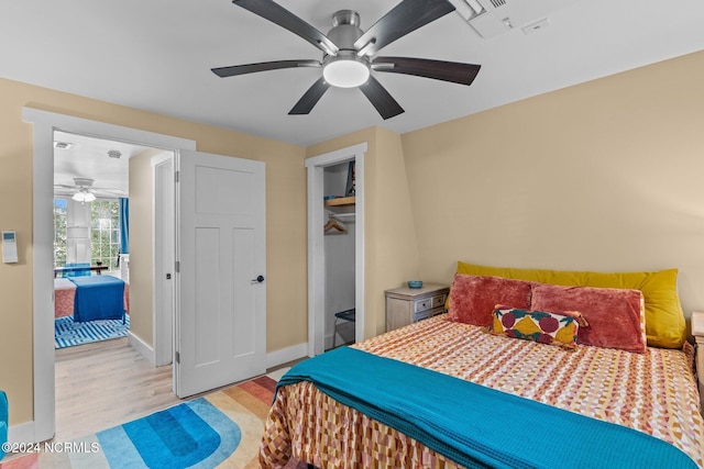 bedroom with a closet, light wood-type flooring, and ceiling fan