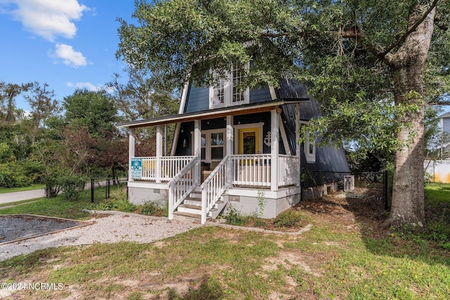 view of front of house with a porch and a front lawn