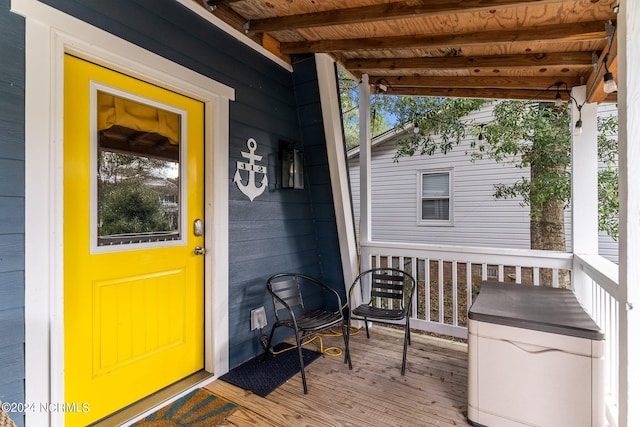 view of exterior entry with a porch