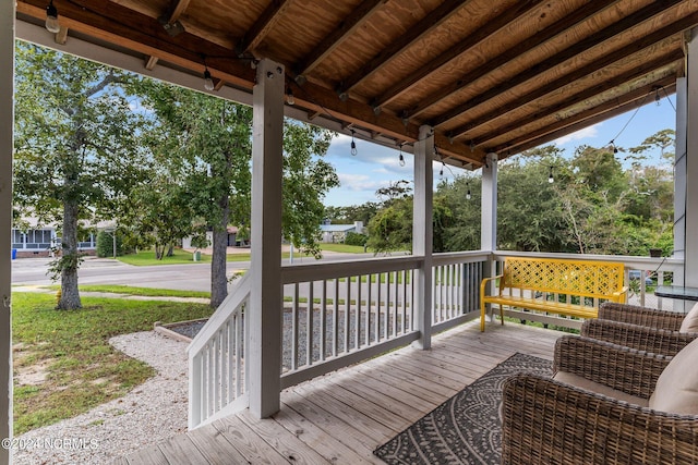 wooden terrace featuring covered porch