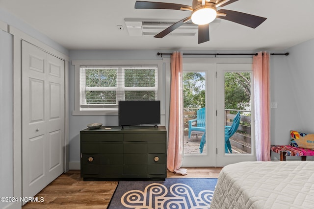 bedroom featuring wood finished floors, a closet, ceiling fan, and access to outside