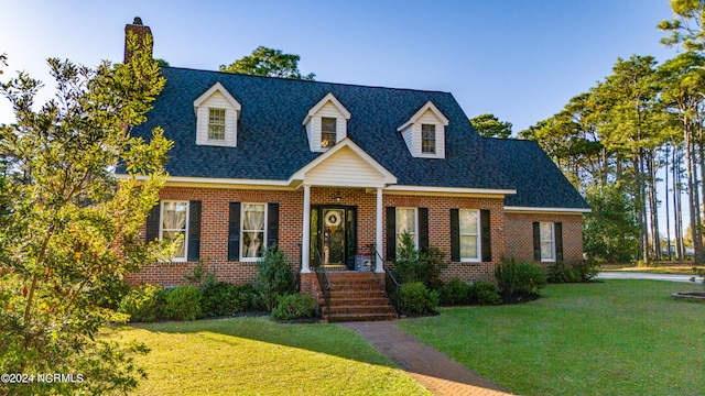 cape cod house with a front lawn