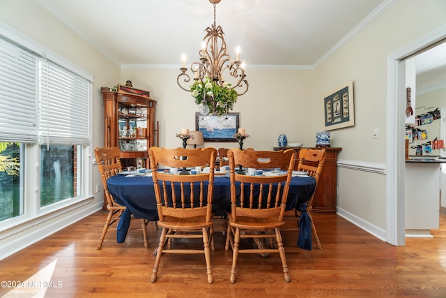 dining space with ornamental molding, a wealth of natural light, and hardwood / wood-style floors