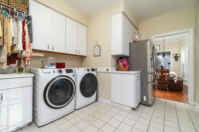 washroom with light tile patterned floors, cabinets, crown molding, and independent washer and dryer