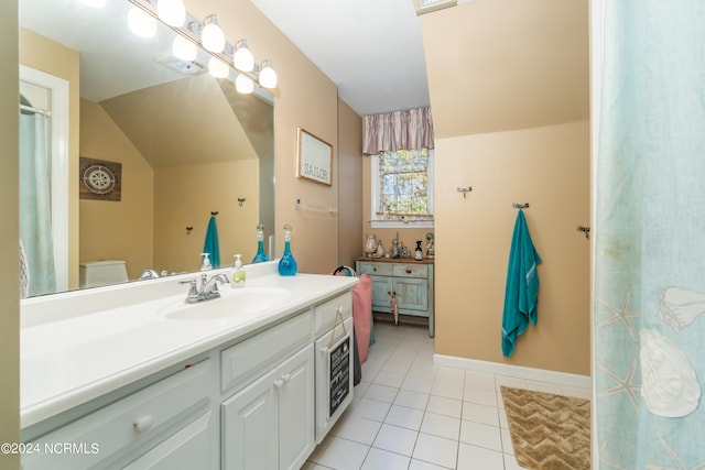 bathroom featuring vanity, tile patterned flooring, and toilet