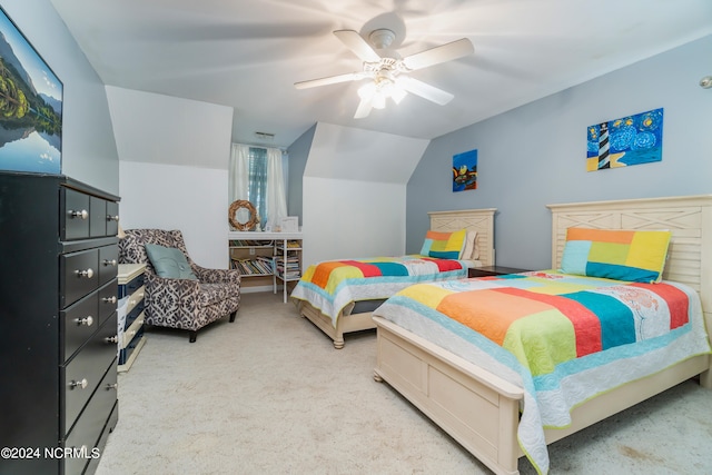 carpeted bedroom with ceiling fan and vaulted ceiling