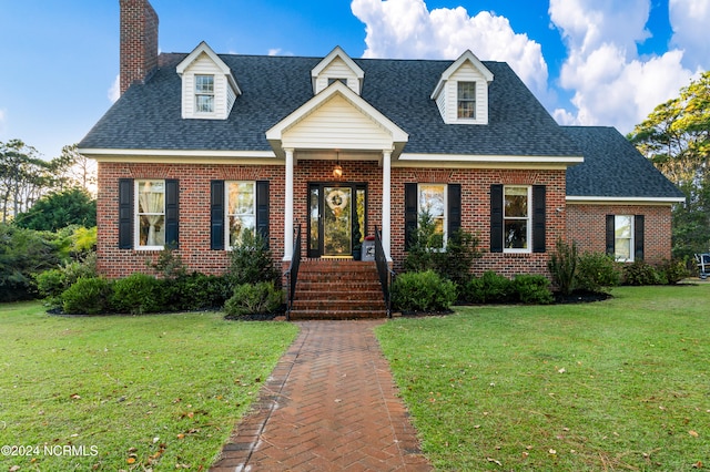 cape cod-style house featuring a front yard