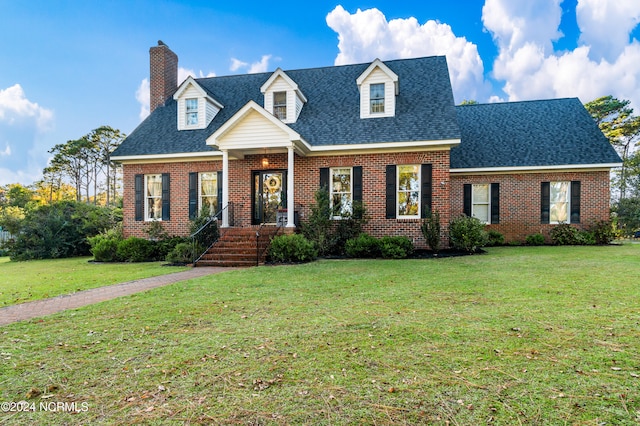 cape cod house with a front lawn