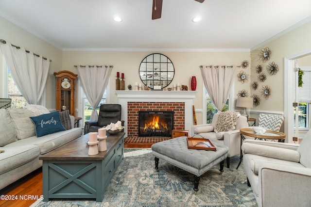 living room with ornamental molding, plenty of natural light, and dark hardwood / wood-style flooring