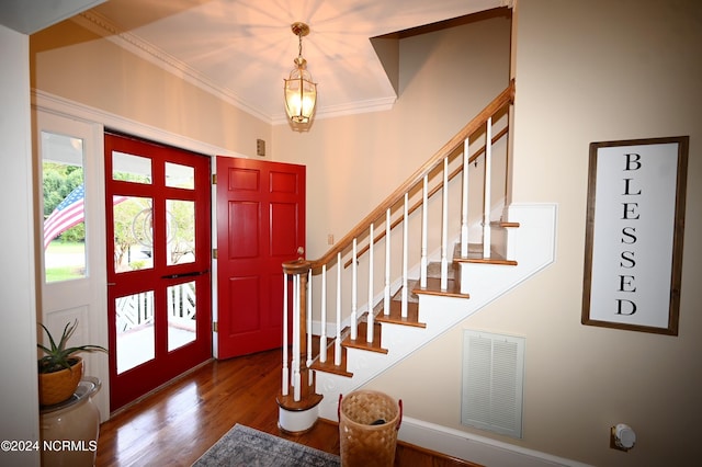 foyer featuring crown molding and hardwood / wood-style floors