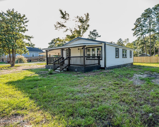 view of front of home featuring covered porch and a front lawn