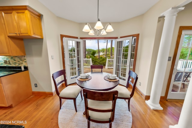 dining space featuring an inviting chandelier, light hardwood / wood-style floors, and a healthy amount of sunlight