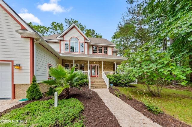 view of front of house featuring covered porch and a garage