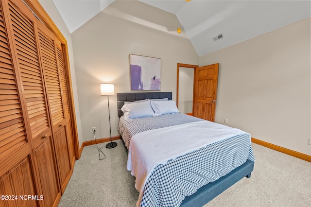 carpeted bedroom featuring lofted ceiling and a closet