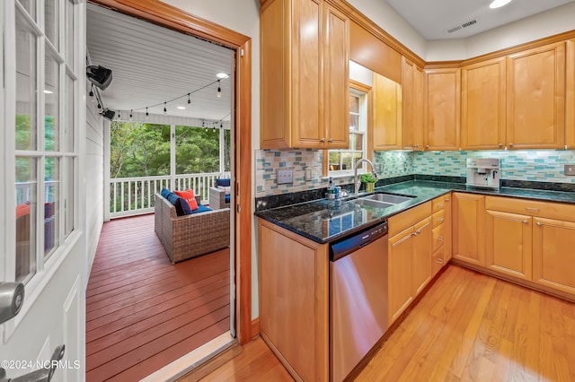 kitchen featuring sink, stainless steel dishwasher, light hardwood / wood-style floors, and tasteful backsplash