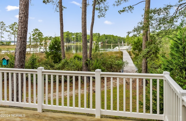 view of yard with a water view and a boat dock