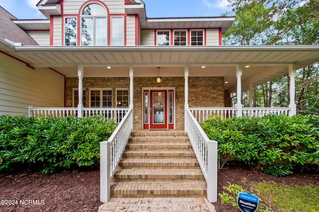 view of exterior entry with a porch