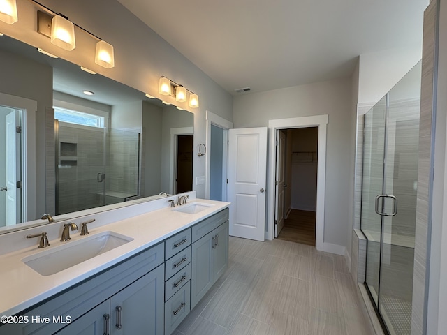 full bathroom with visible vents, a sink, and a shower stall