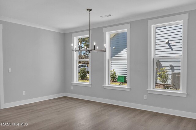 unfurnished bedroom featuring ceiling fan, ensuite bathroom, a tray ceiling, and light wood-type flooring