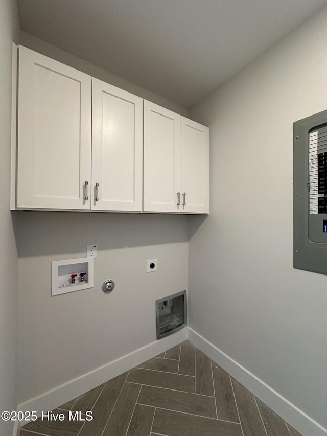 washroom with washer hookup, cabinet space, hookup for an electric dryer, electric panel, and baseboards