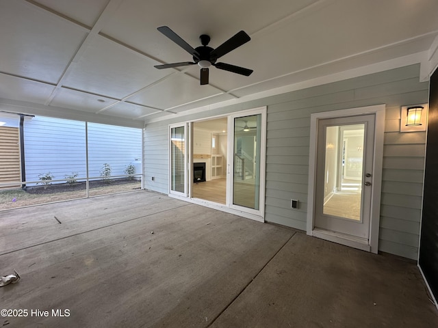 unfurnished sunroom featuring ceiling fan