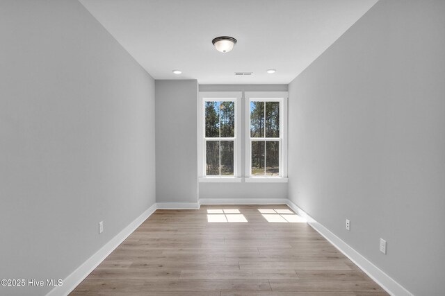 living room with a barn door, high vaulted ceiling, and light wood-type flooring