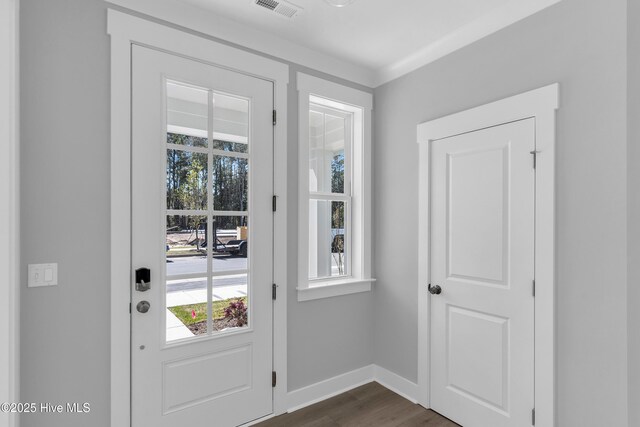 unfurnished living room with ornamental molding, a wealth of natural light, and a fireplace