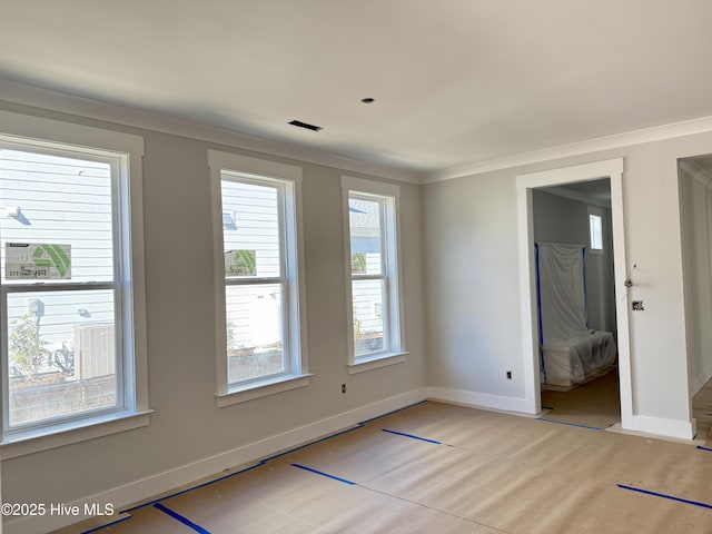 unfurnished room featuring ornamental molding