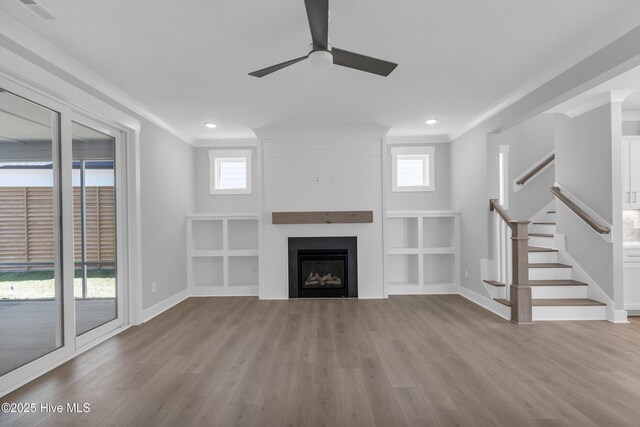 spare room featuring a tray ceiling, baseboards, visible vents, and wood finished floors