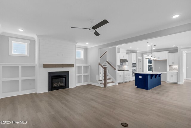 kitchen featuring stainless steel appliances, white cabinetry, sink, and pendant lighting